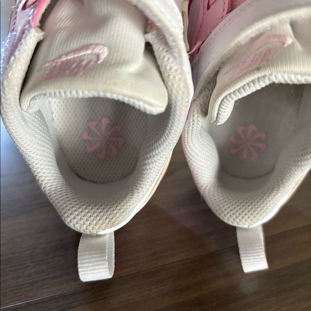 Nike pink and white toddler shoe.